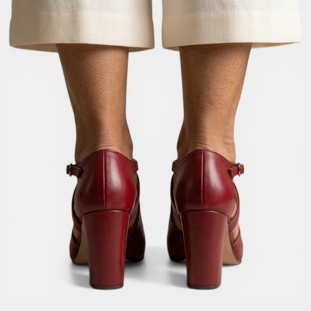 Model wearing elegant women's T-strap high heel sandals; comfortable formal evening wear with a chic round toe.