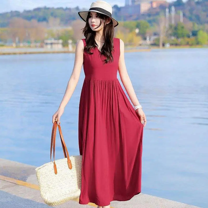 Women's elegant V-neck maxi dress with tie waist, sleeveless design & practical pockets.