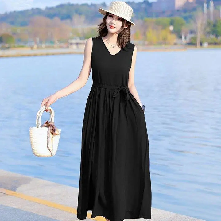 Elegant flowy V-neck maxi dress for women, with tie waist, sleeveless cut & convenient pockets.