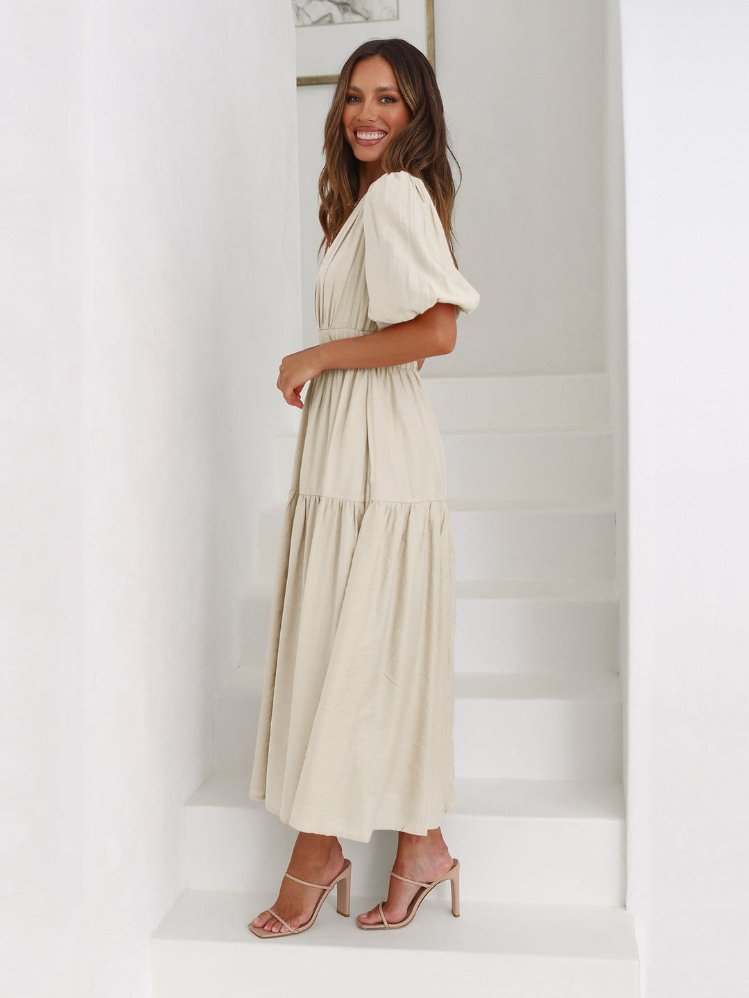 Modern women's V-neck midi dress, with on-trend puff sleeves and a flattering smocked waist.