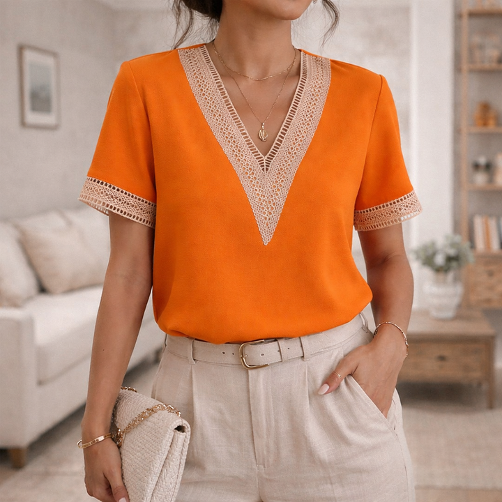 Relaxed fit women's V-neck top with chic lace trim, ideal for everyday elegant and comfortable style.