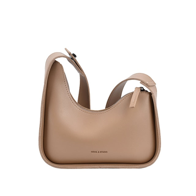 Women's elegant wave shoulder bag in chic PU leather, a versatile fashion accessory.