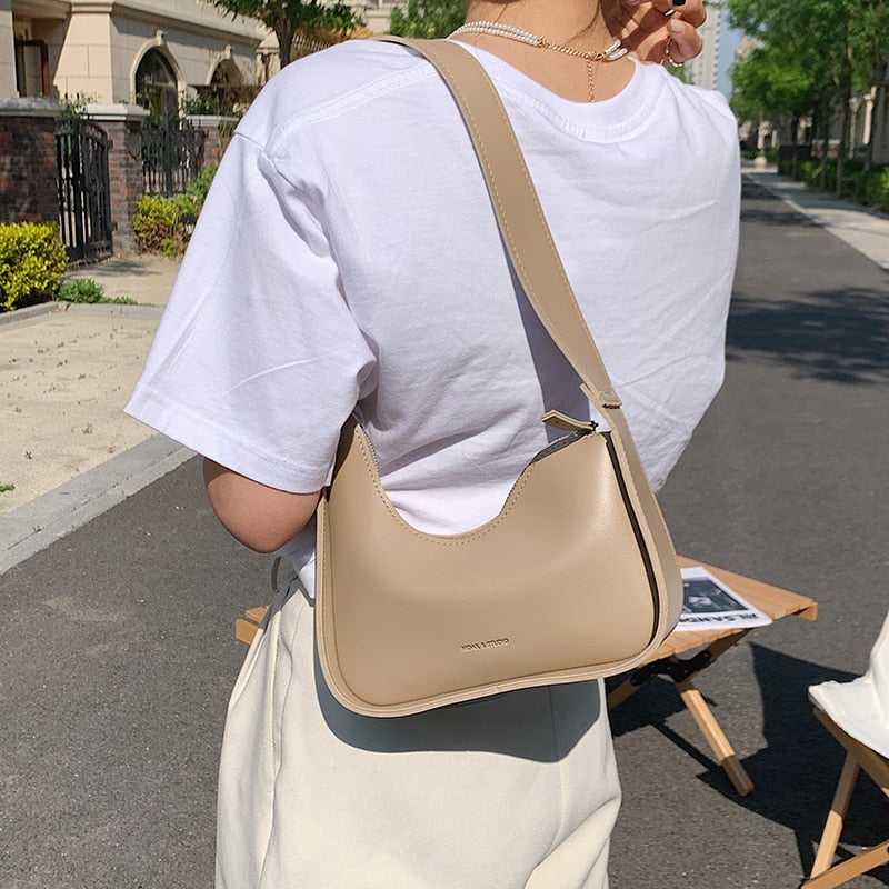 Chic PU leather handbag for women, showcasing an elegant wave pattern.