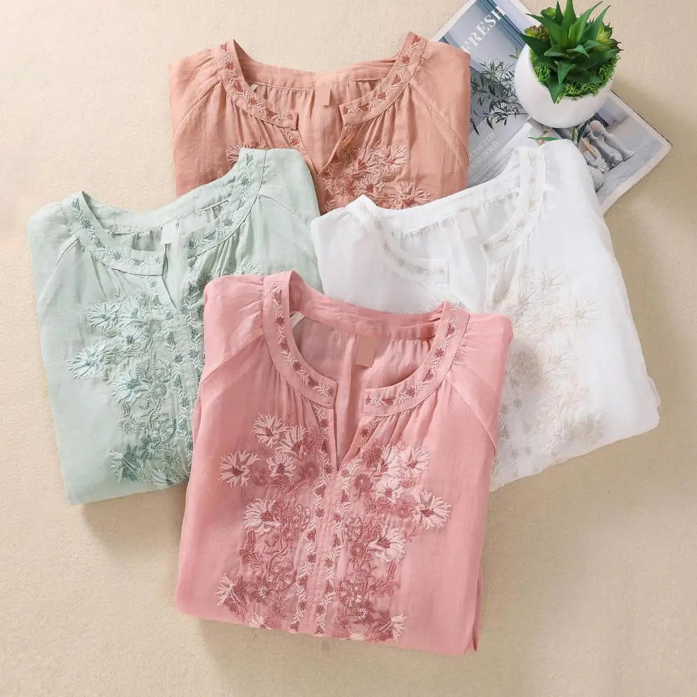 Elegant women's white blouse with intricate floral embroidery, gathered details. Perfect for spring/summer.