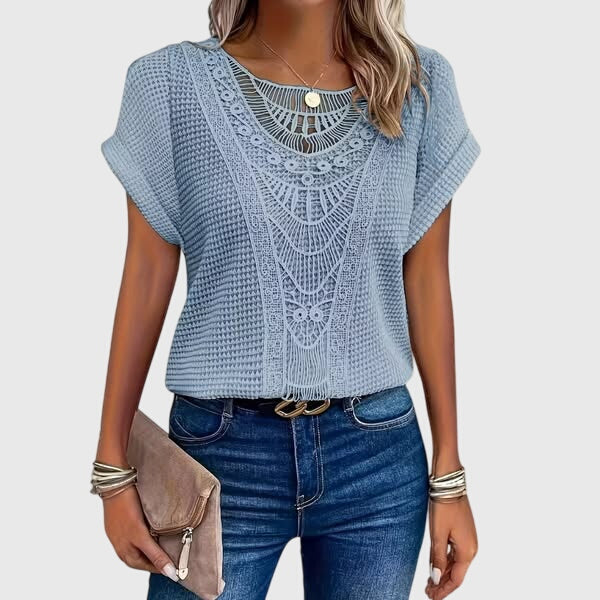 Close-up of intricate lace on a women's elegant Ibiza style summer blouse, very versatile.