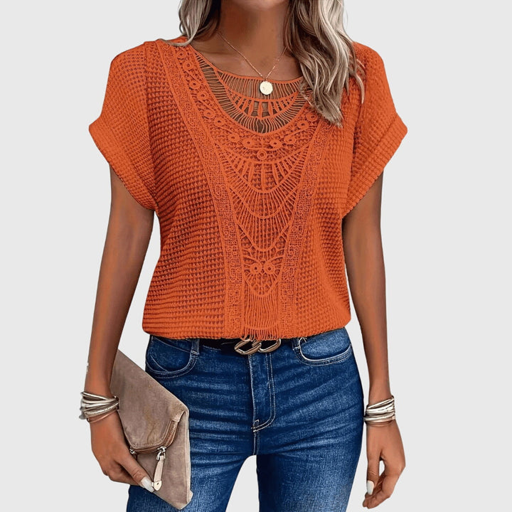 Front view of a chic women's Ibiza style lace blouse, versatile for elegant summer looks.