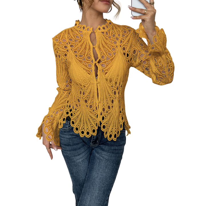 Close-up of intricate lace cutwork detail on an elegant white long sleeve women's blouse, showcasing its romantic style.