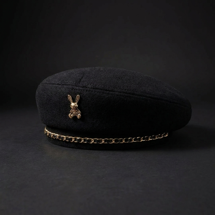 Elegant beige women's wool-blend cap, featuring a sophisticated golden bee emblem. A chic fashion accessory.