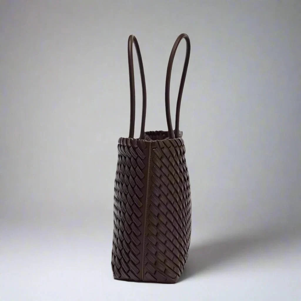 Close-up of elegant woven genuine leather handbag for women, sophisticated everyday purse.
