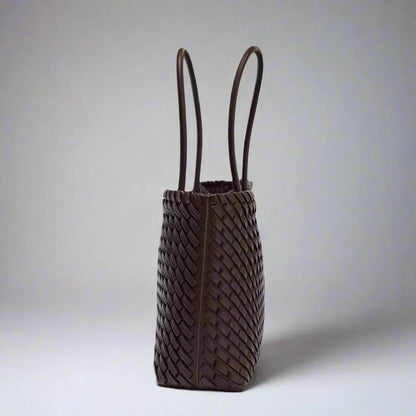Close-up of elegant woven genuine leather handbag for women, sophisticated everyday purse.