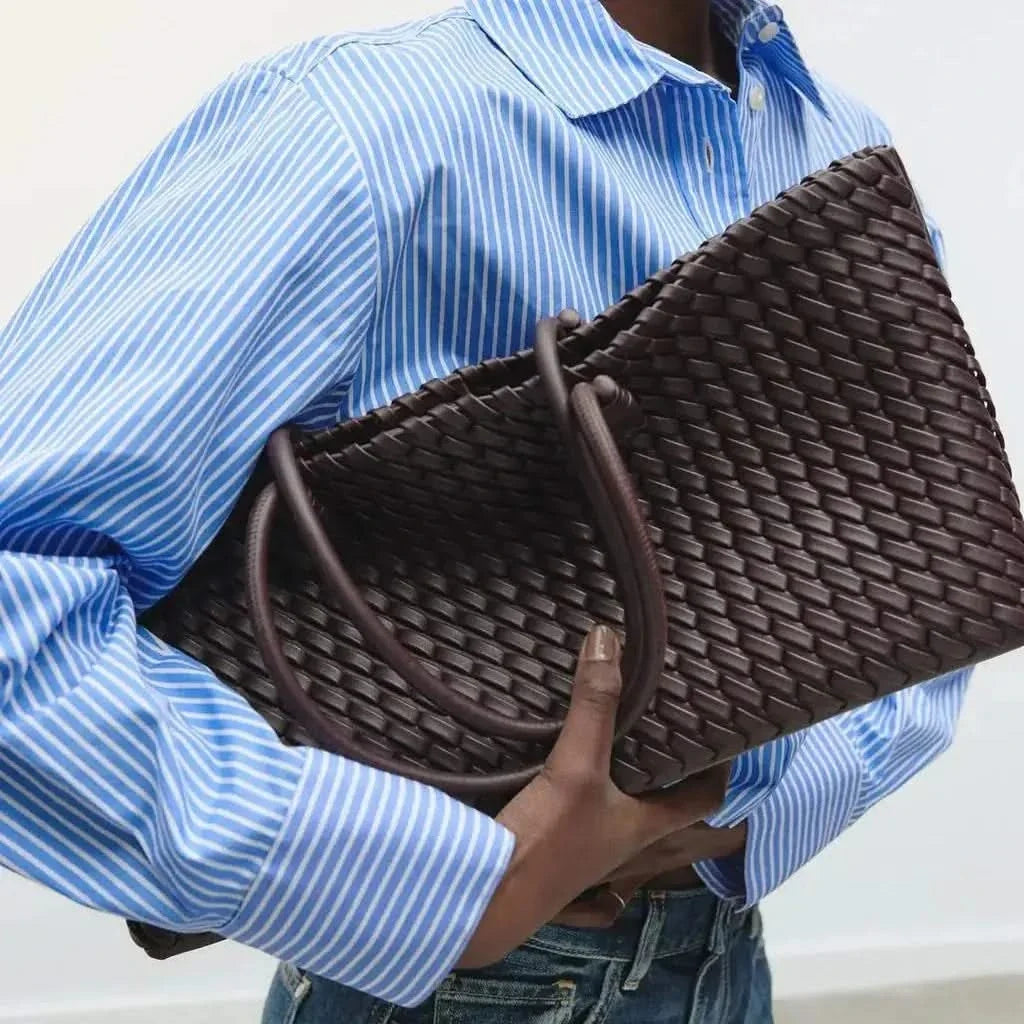 Women's elegant woven leather shoulder handbag, featuring intricate design for fashion.