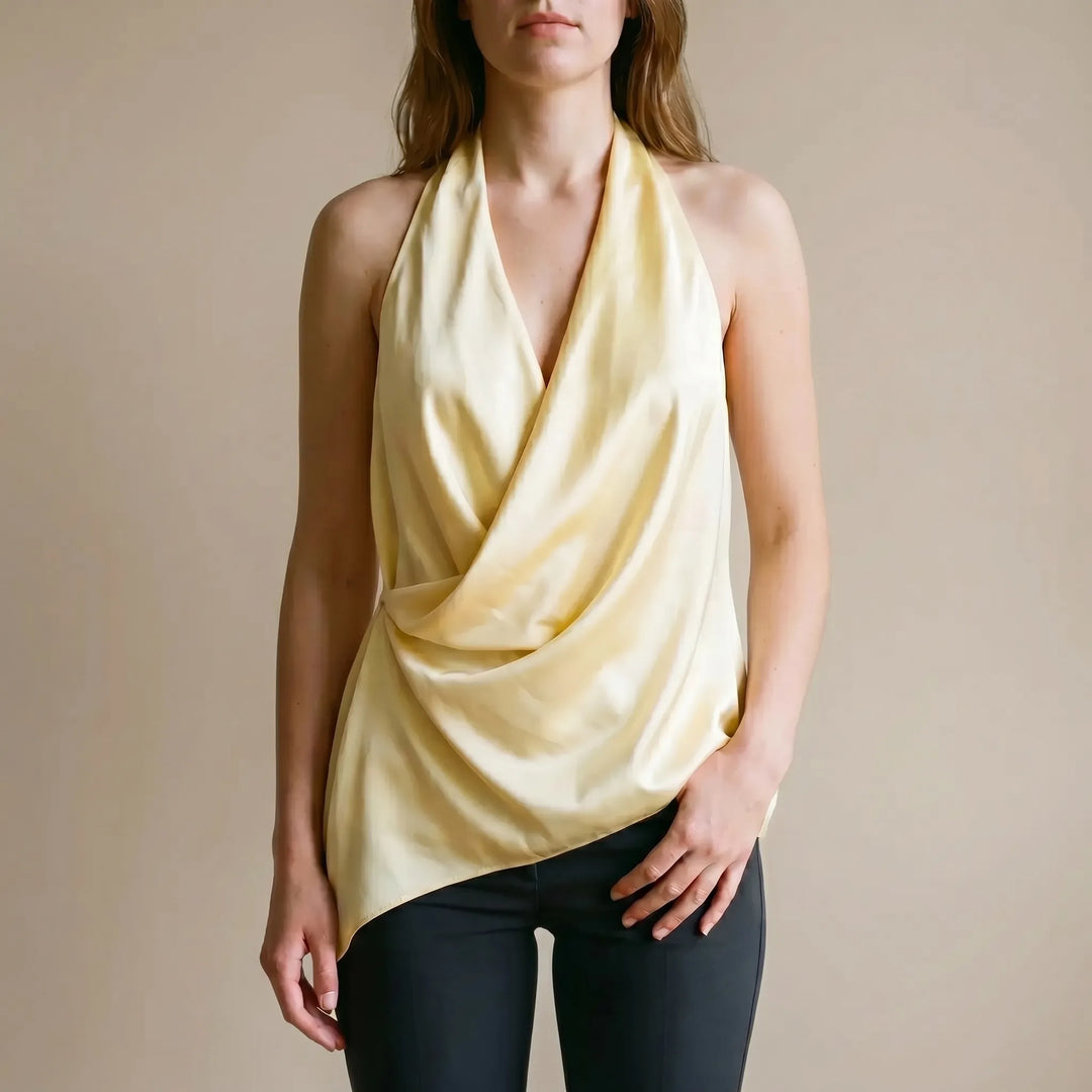 Women's elegant yellow draped halter top with asymmetrical hem, perfect for summer evening wear.