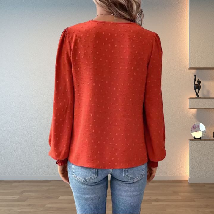 Fashionable women's long sleeve V-neck blouse with puff sleeves & intricate embroidery for a relaxed, elegant look.