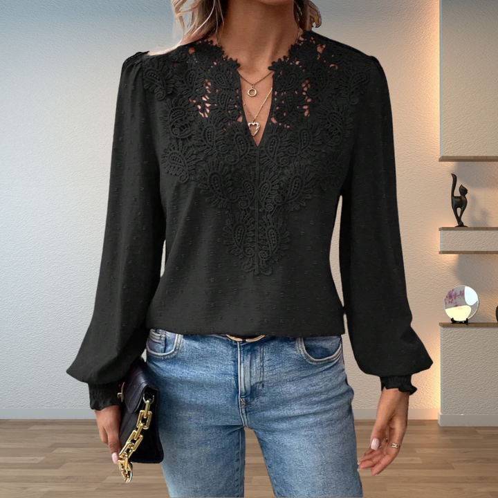 Relaxed fit women's V-neck blouse featuring delicate embroidery & long sleeves, blending casual comfort with style.