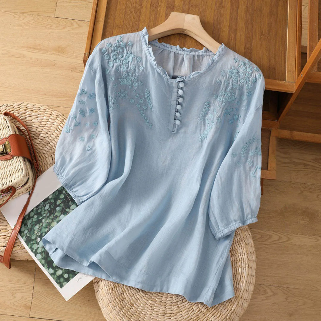 Women's embroidered vintage blouse with delicate stitching, long sleeves, and button-down front. Elegant casual chic top.