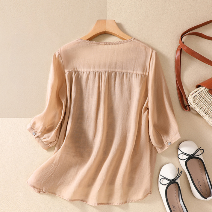 Women's floral lace summer blouse, offering a relaxed fit and elegant style for warm weather comfort.