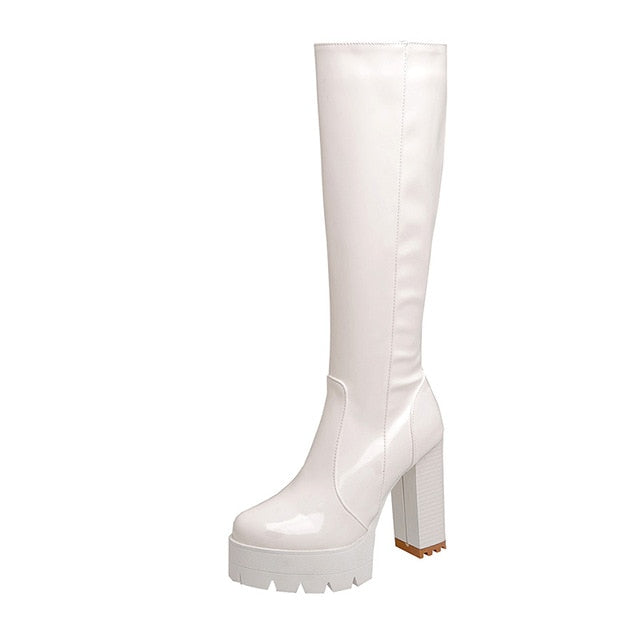 Elegant women's studded black long boots with platform & chunky heels. Stylish footwear for fall & winter fashion.