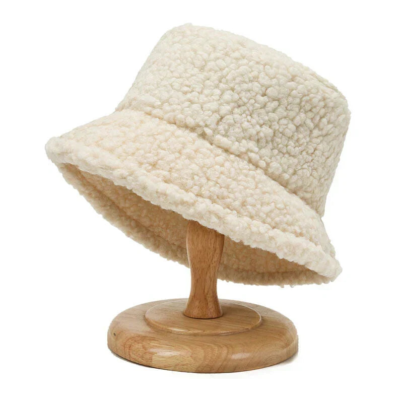 Women's fashionable plush bucket hat for winter. Cozy faux fur headwear.
