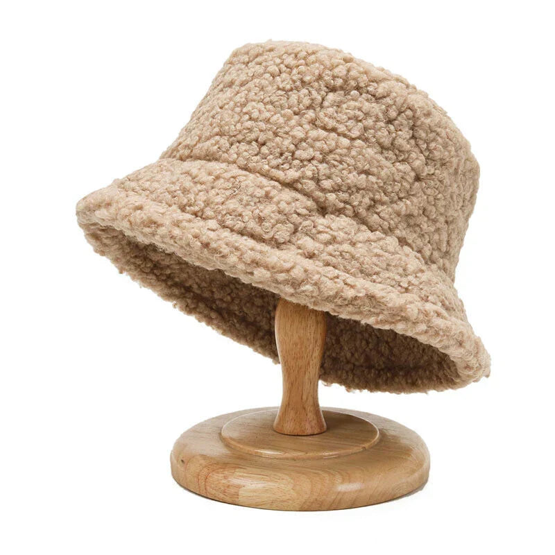 Trendy women's plush bucket hat, perfect for winter fashion. Warm & cozy faux fur accessory.