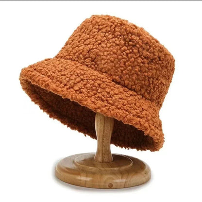 Soft faux fur plush bucket hat for women. Stylish winter accessory keeps you warm & trendy.