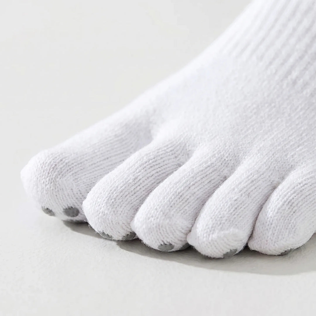 Woman's feet in five-toe activewear grip socks, showcasing comfort & improved balance for yoga, pilates & exercise.