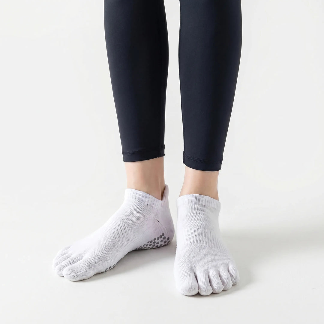 Five-toe design of women's grip socks, promoting better toe spread and stability for yoga, pilates, and studio fitness.