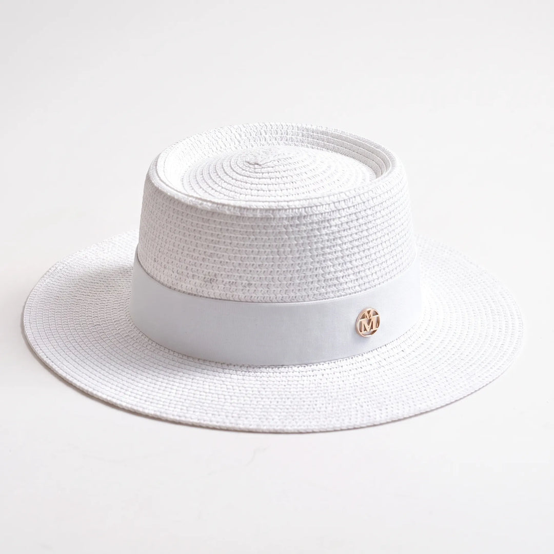 Stylish women's wide brim sun hat with a flat top design. Ideal for beach days, travel, or resort wear.