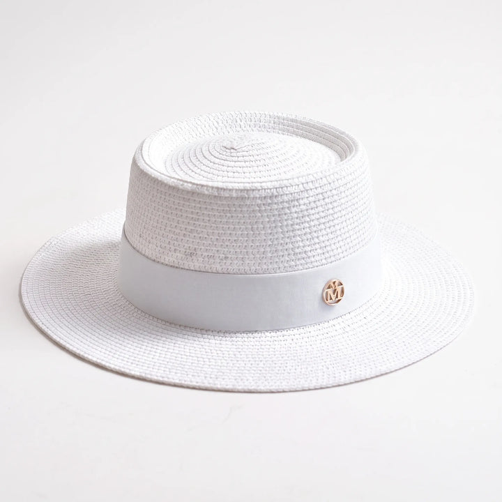Stylish women's wide brim sun hat with a flat top design. Ideal for beach days, travel, or resort wear.