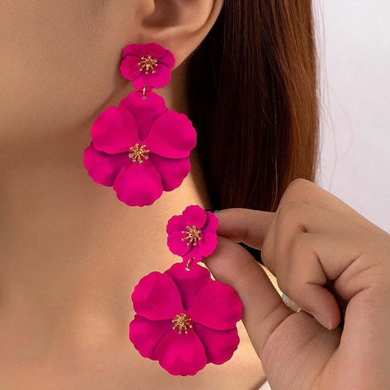 Women's Fleura Cascade floral drop earrings in vibrant fuchsia & white, a stylish fashion accessory.