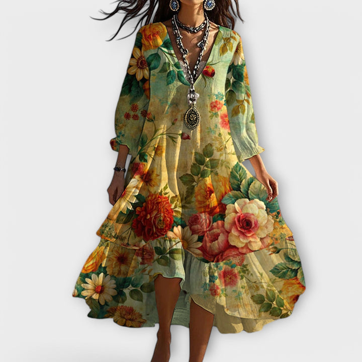 Women's floral boho maxi dress with V-neck, long sleeves, and flowy silhouette. Perfect for summer resort wear.
