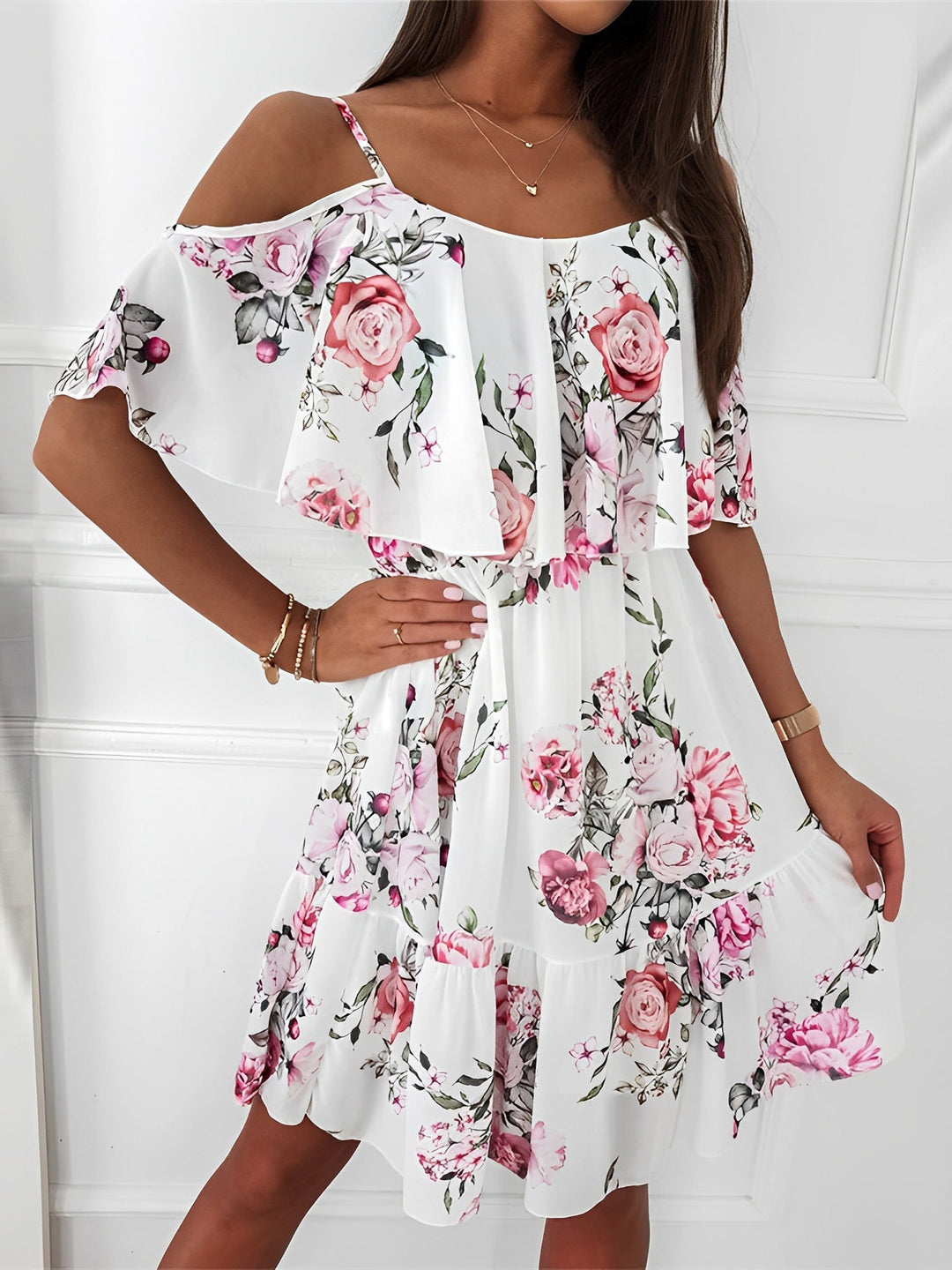 Women's floral cold shoulder mini dress with playful ruffle trim, perfect for summer.