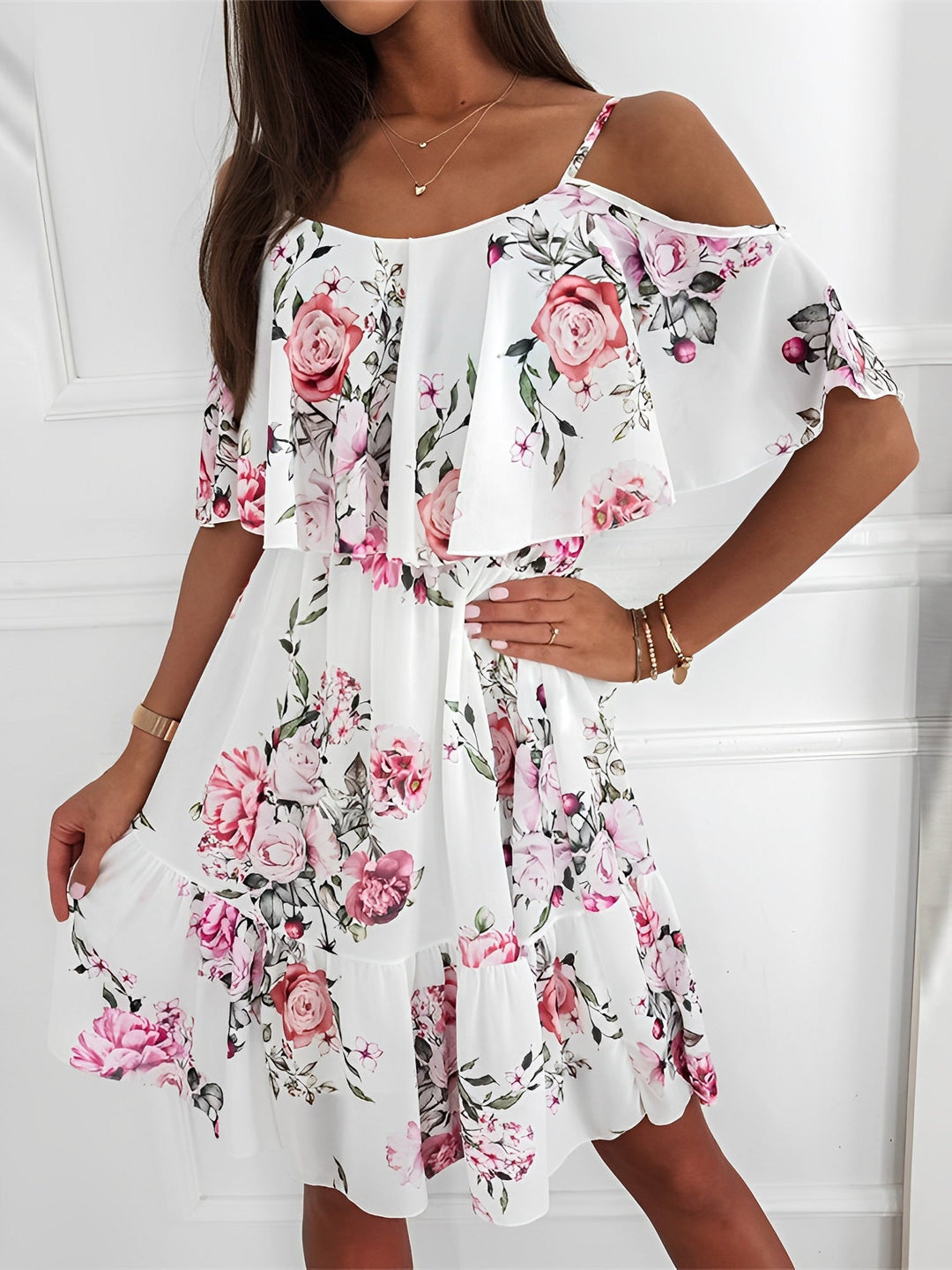 Casual women's floral mini dress featuring cold shoulder and delicate ruffle details.
