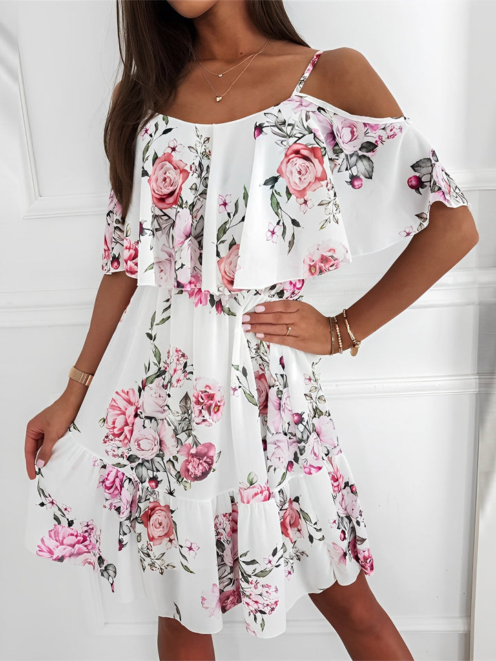 Casual women's floral mini dress featuring cold shoulder and delicate ruffle details.
