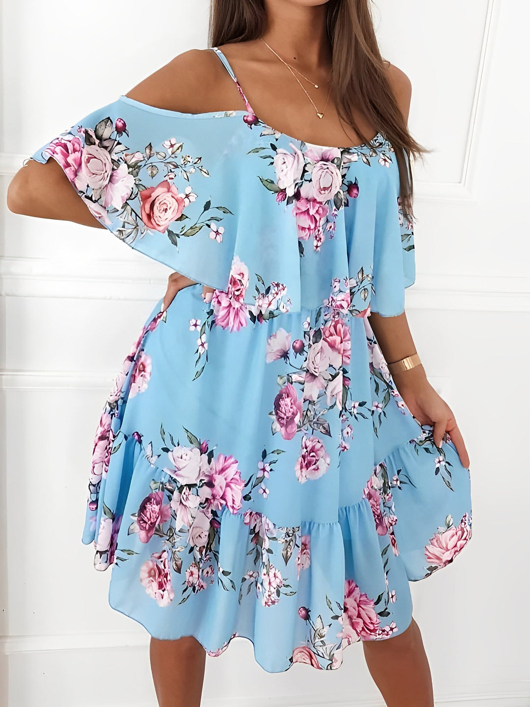 Model showcases a feminine floral cold shoulder ruffle mini dress, great for casual parties.