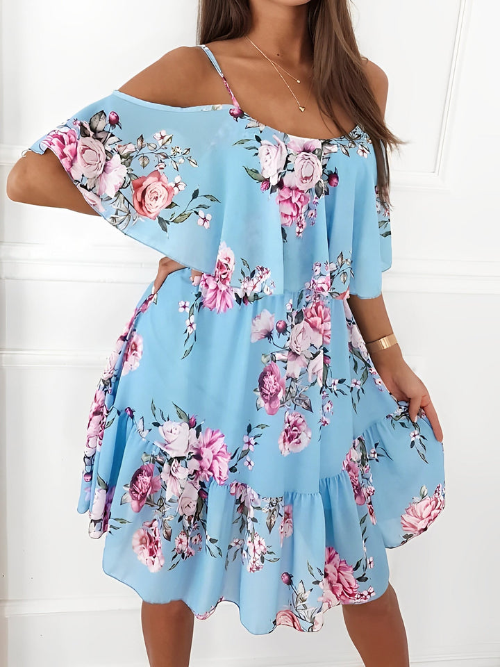 Model showcases a feminine floral cold shoulder ruffle mini dress, great for casual parties.