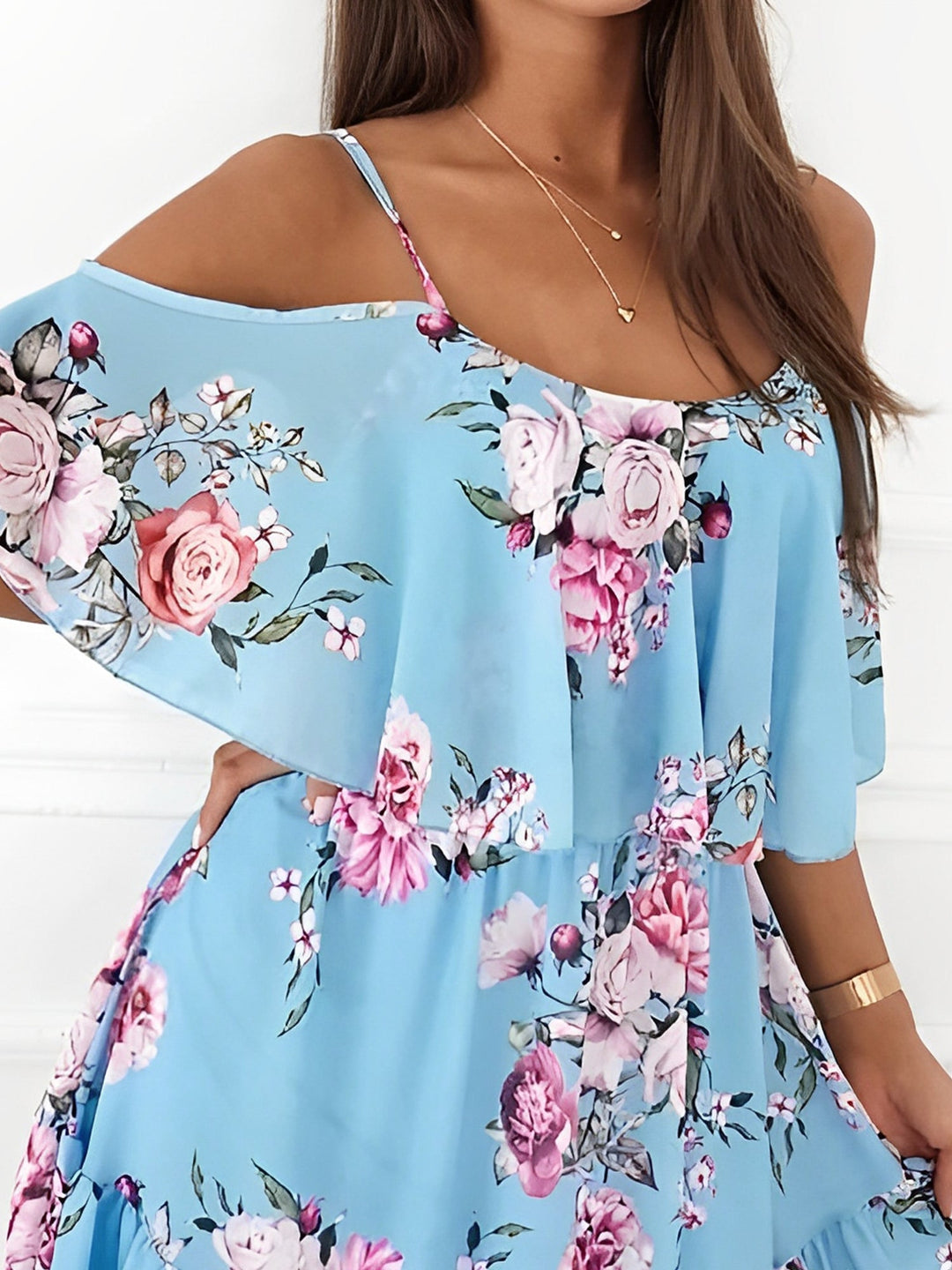 Comfortable women's floral mini dress with cold shoulder cutouts and a flirty ruffle hem.