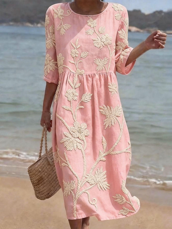 Elegant casual women's midi dress, featuring intricate floral embroidery and comfortable three-quarter sleeves.