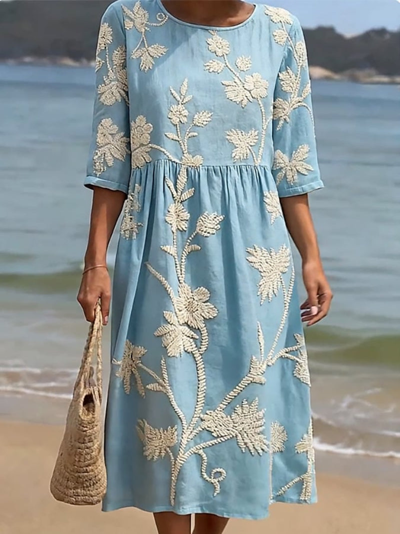 Relaxed fit women's summer midi dress, delicate floral embroidery, three-quarter sleeves for warm weather style.