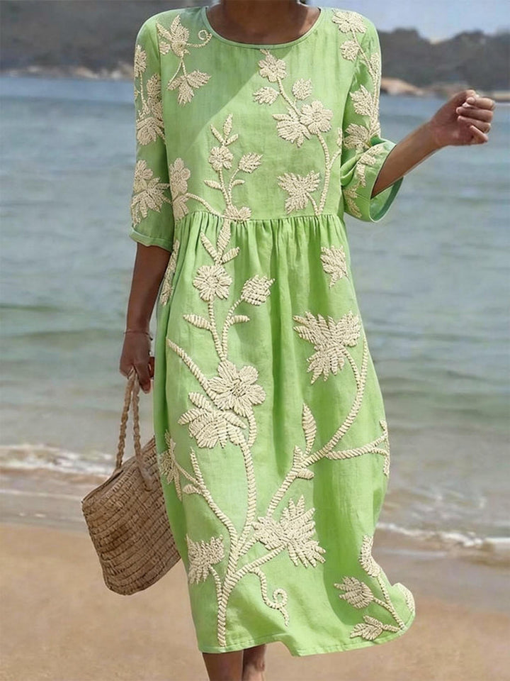 Stylish women's day dress: floral embroidered midi with three-quarter sleeves, ideal for casual spring outfits.
