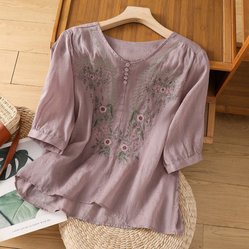 Feminine V-neck blouse for women, featuring delicate floral embroidery & a relaxed silhouette. Spring/summer.
