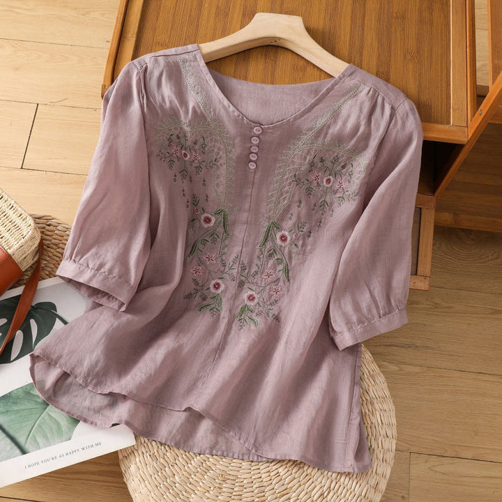 Feminine V-neck blouse for women, featuring delicate floral embroidery & a relaxed silhouette. Spring/summer.