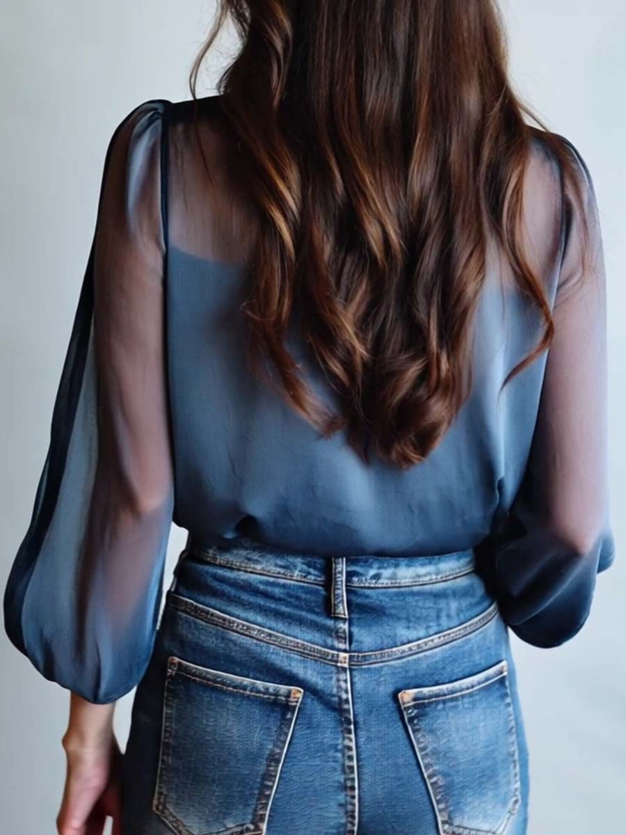Stylish women's V-neck blouse, featuring intricate floral embroidery and fashionable sheer long sleeves.