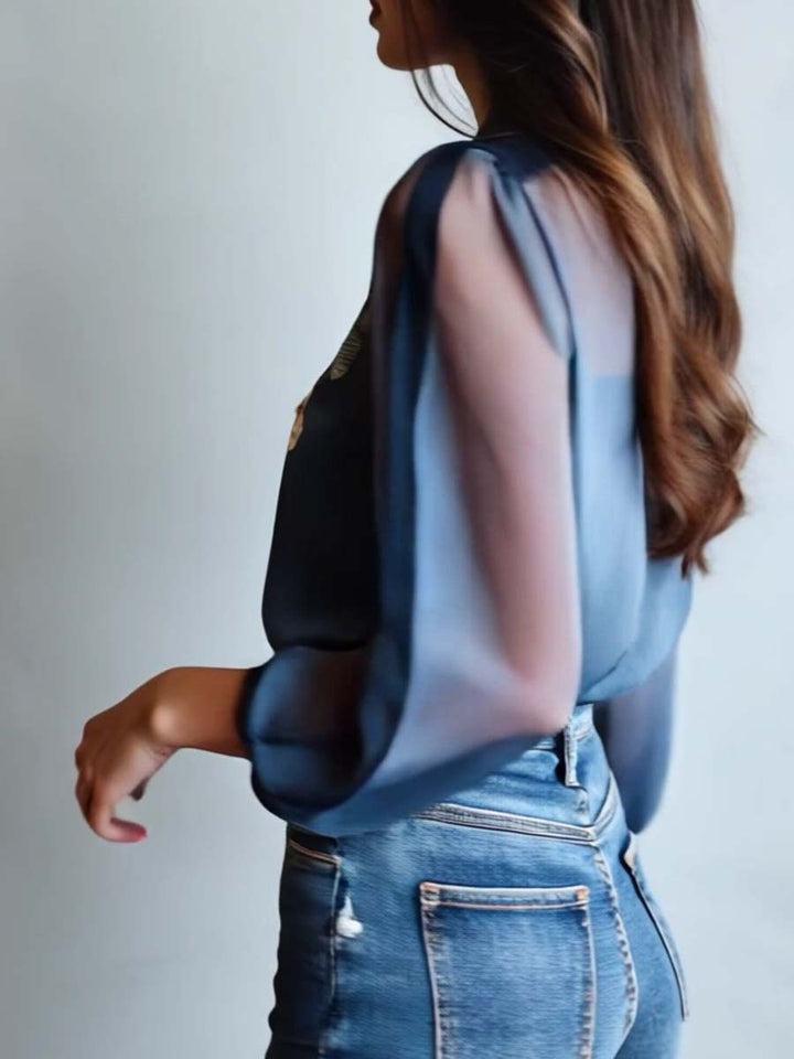 Feminine women's blouse with delicate floral embroidery & sheer long sleeves. Stylish for casual or evening wear.