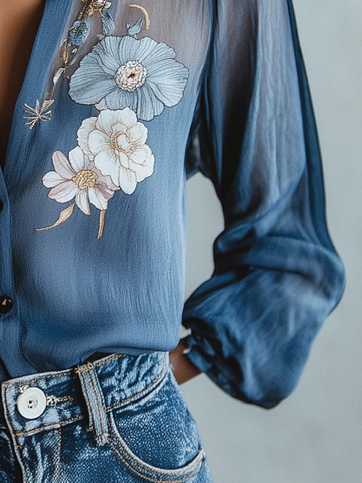 Relaxed fit women's top with feminine floral embroidery and stylish sheer sleeves, suitable for any occasion.