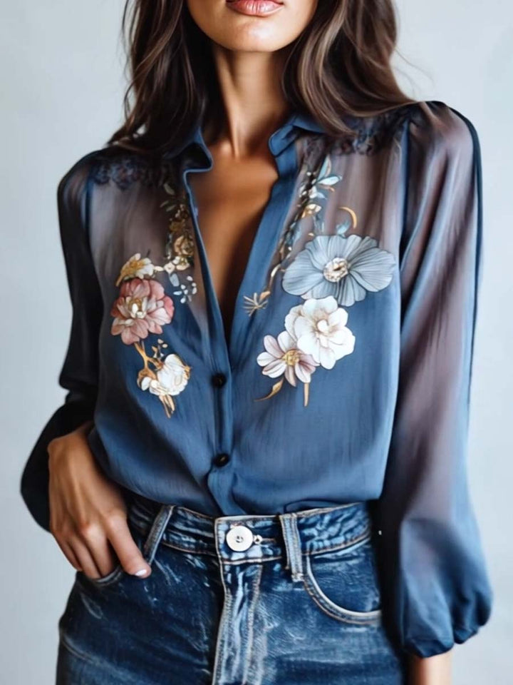 Trendy women's sheer sleeve blouse, adorned with vibrant floral embroidery and a flattering V-neck design.