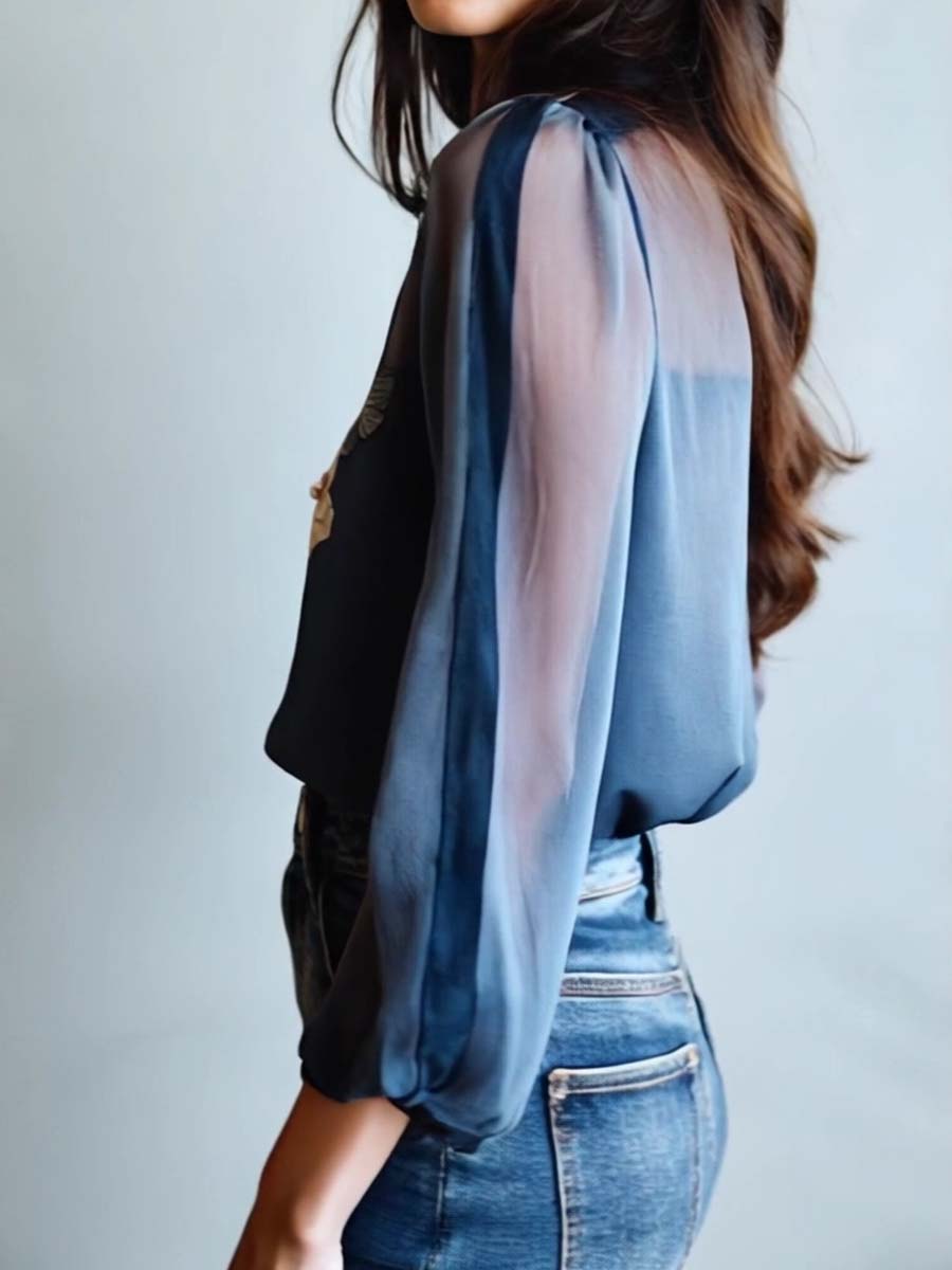 Elegant women's blouse for evening wear, with intricate floral embroidery and chic sheer long sleeves.