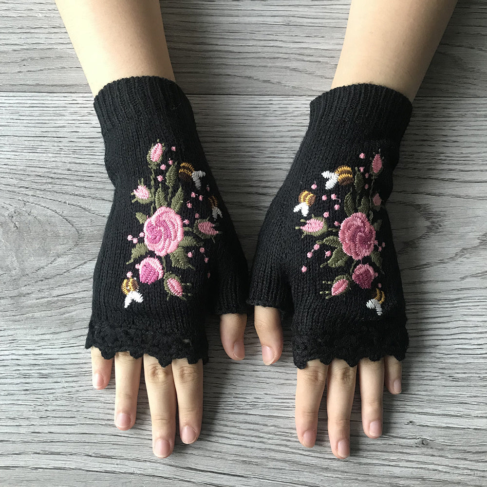 Chic women's knit fingerless gloves with intricate floral embroidery. A cozy boho winter fashion accessory.