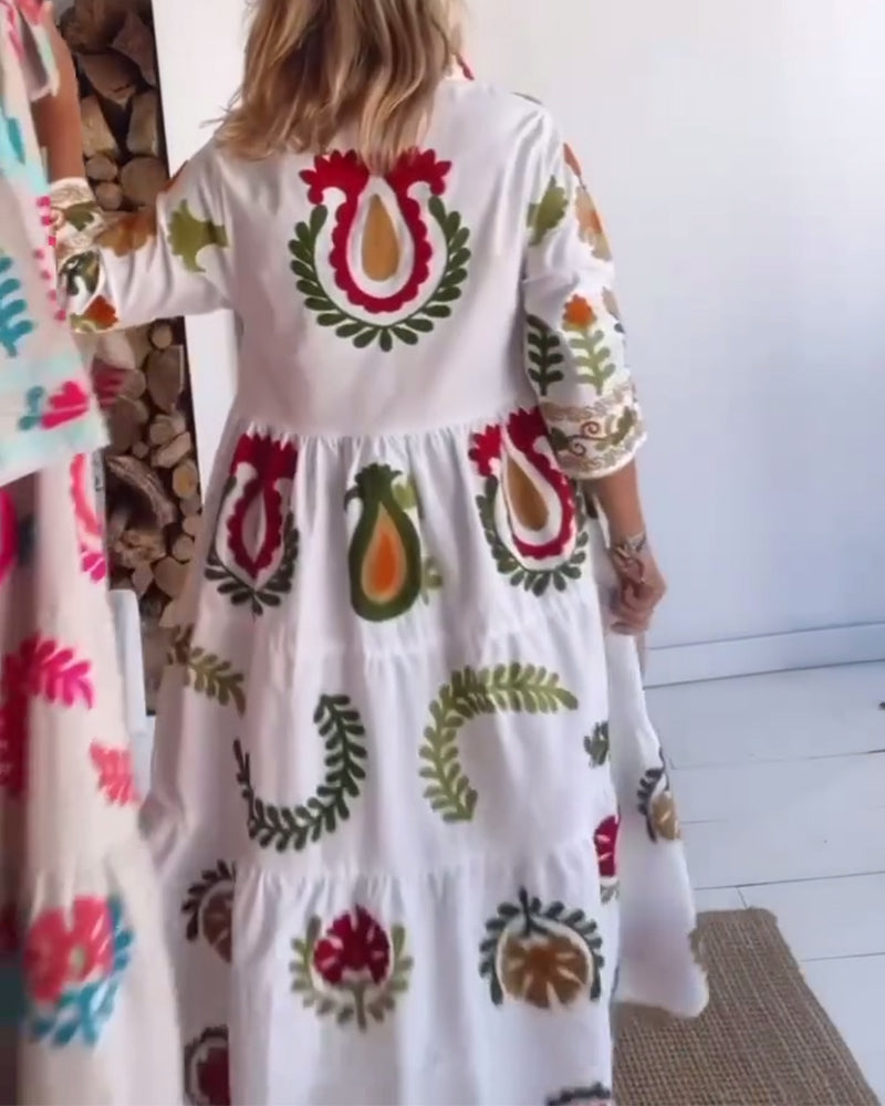 Vibrant women's floral midi dress with a graphic print and a classic lapel collar. Great for spring fashion.