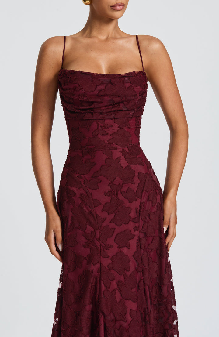 Side view of women's floral maxi dress, highlighting its A-line silhouette and flowy hem.