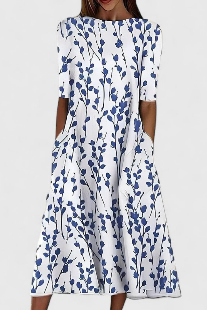 Women's floral print midi dress with short sleeves, relaxed A-line fit & practical pockets for summer casual wear.